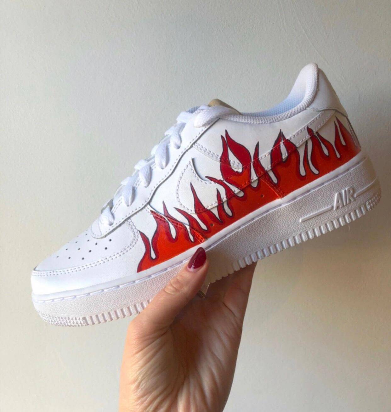 flames red and orange with black outline on well known high end brand nike, air force 1 these are hand painted designs