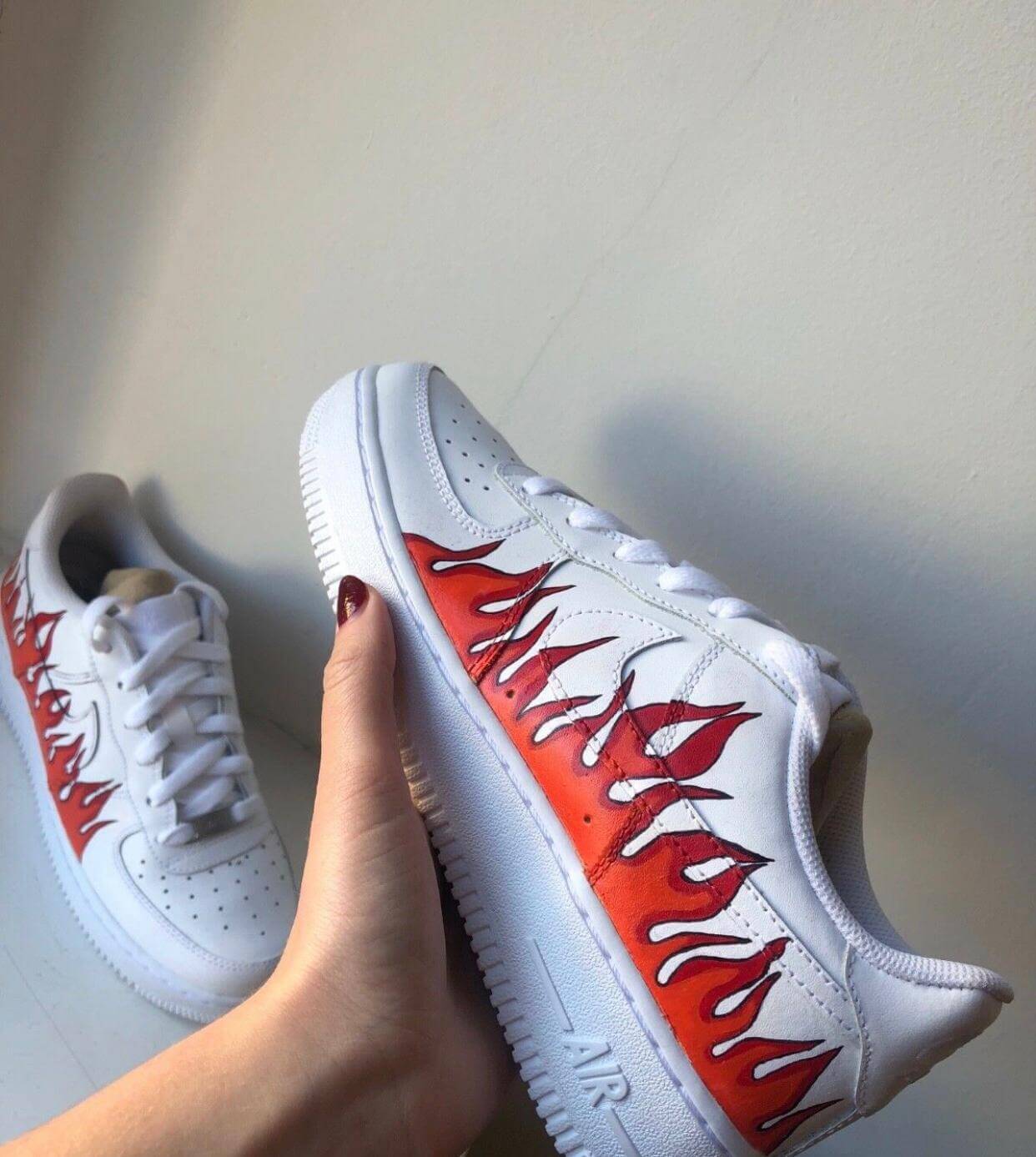 flames red and orange with black outline on well known high end brand nike, air force 1 these are hand painted designs